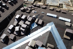 close-up aerial view of roof finish materials stacked on a rooftop preparing for installation of the roof finish material