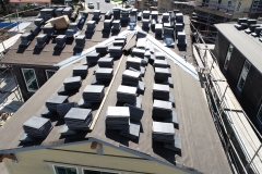 aerial view of rooftop after dry-in with short stacks of roof finish material all over