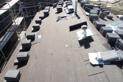 close-up aerial view of roof finish materials stacked on a rooftop ready for installation