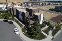 aerial view of development site with buildings and lots at various stages of construction