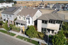 aerial view of development site with buildings and lots at various stages of construction