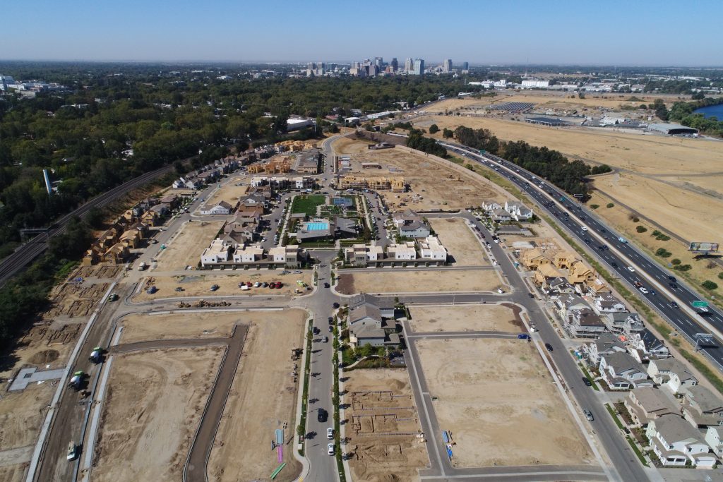 aerial view of a new residential community showing homes and lots at various stages of construction