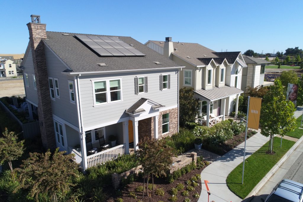 aerial view of row of new construction single family homes used for marketing